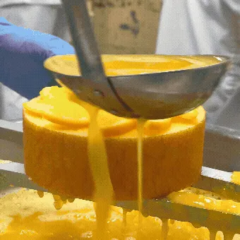 職人が丁寧にオレンジソースをかける様子