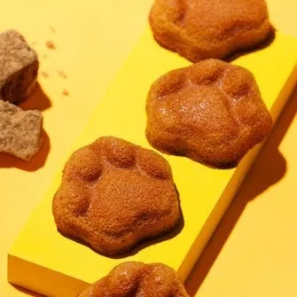 黄色い台に並べられた肉球型のフィナンシェ