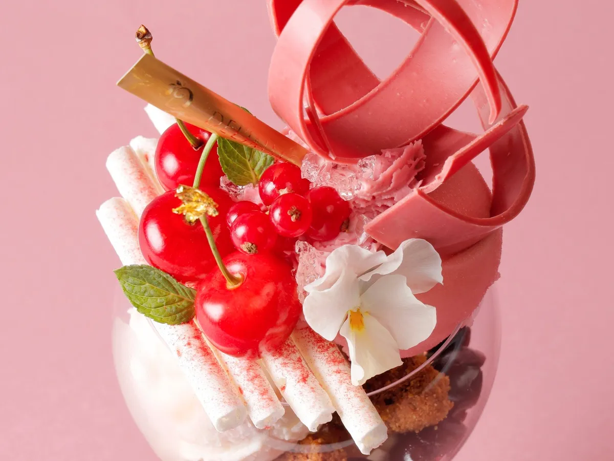パフェのトップに飾られたルビーチョコとさくらんぼ