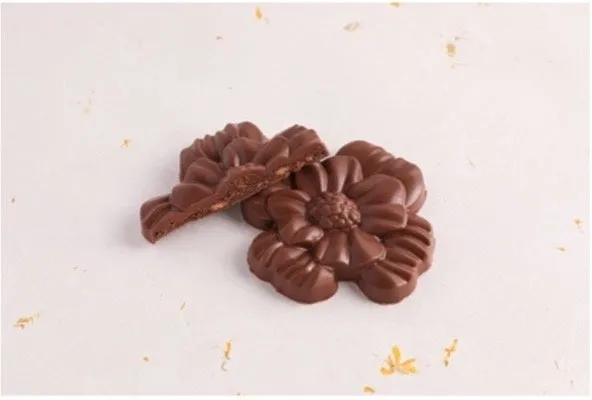 断面からとろりとしたフィリングが覗く花の形のミルクチョコレート