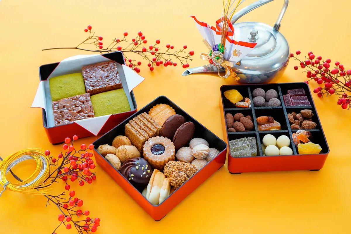 お菓子なおせち。3段の重箱にクッキーやチョコレートがぎっしり詰まった様子